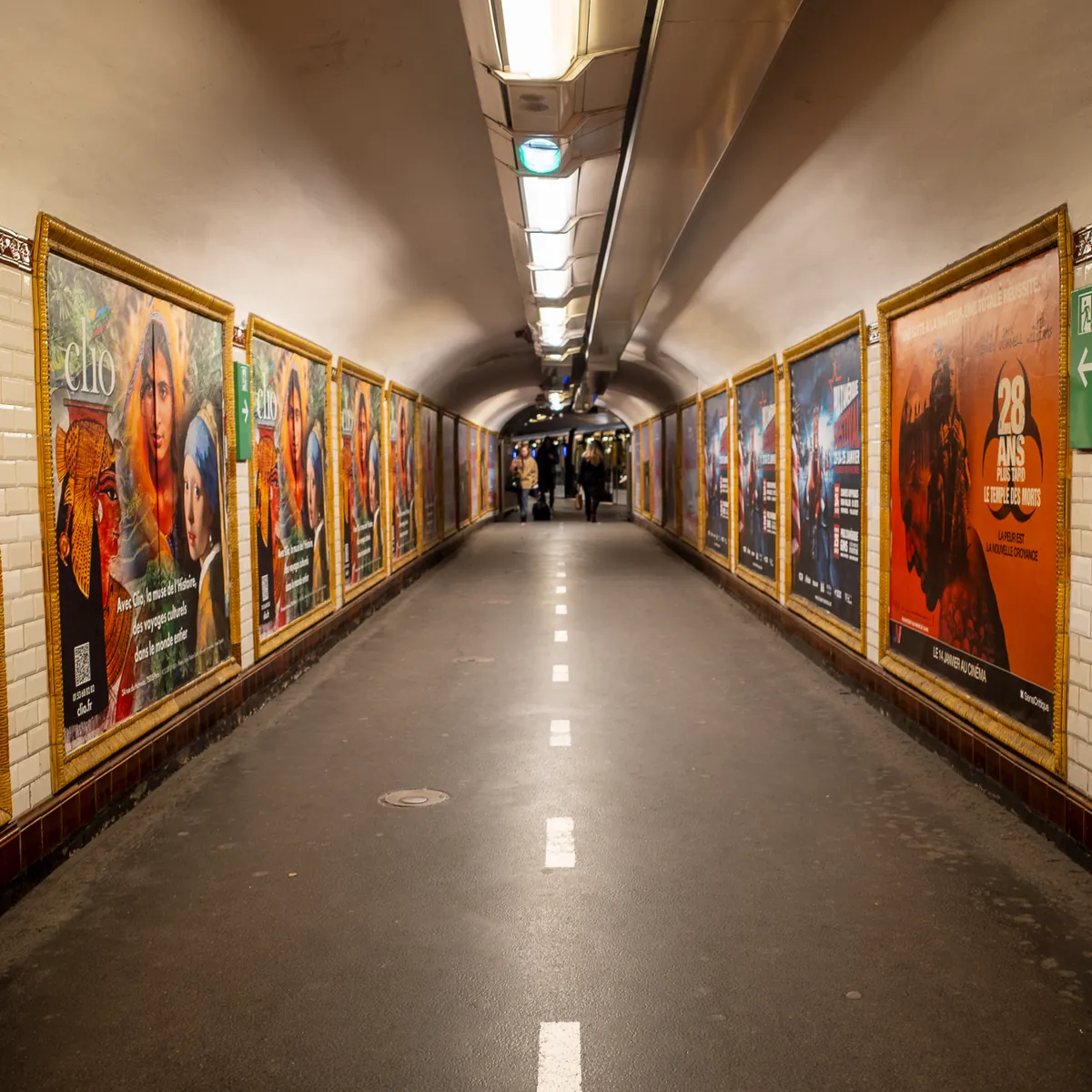 An empty Metro corridor lined with framed posters.